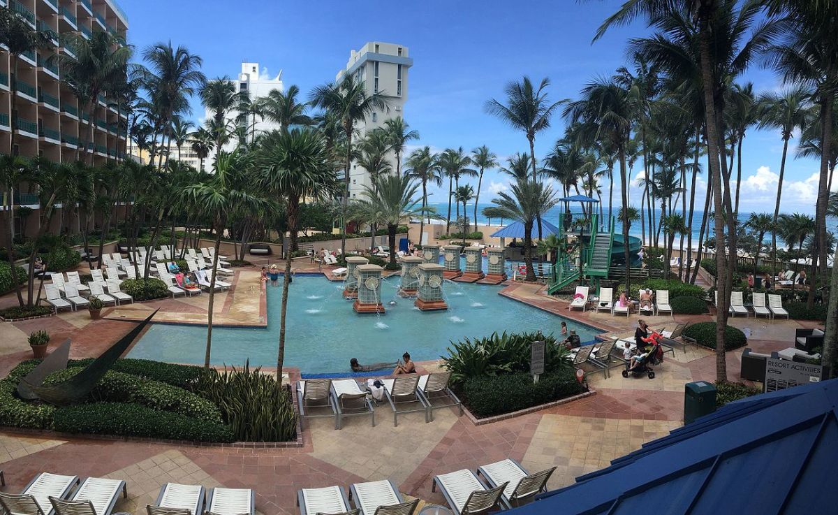 San_Juan_Marriott_Resort__Stellaris_Casino_gardens A hotel pool during the day with people lounging around