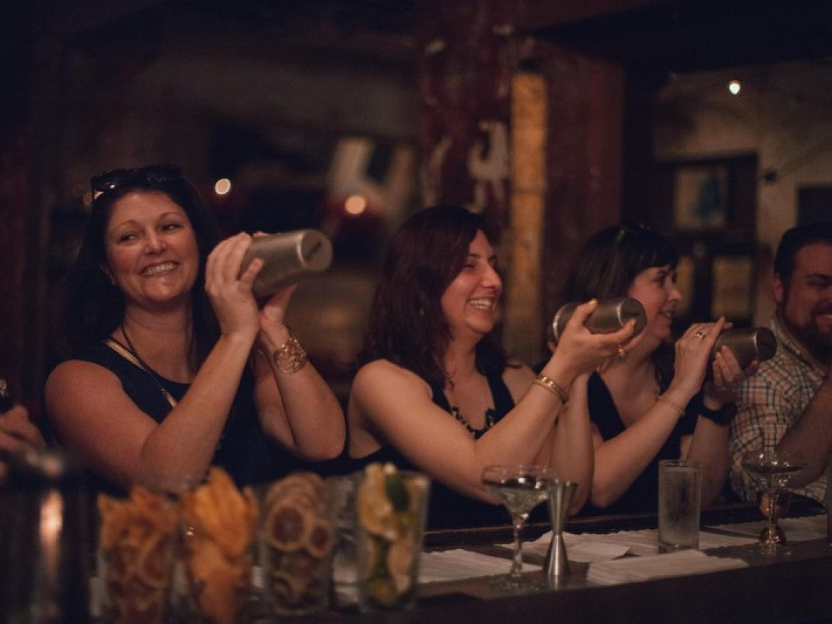 a group of people standing in front of a mirror posing for the camera