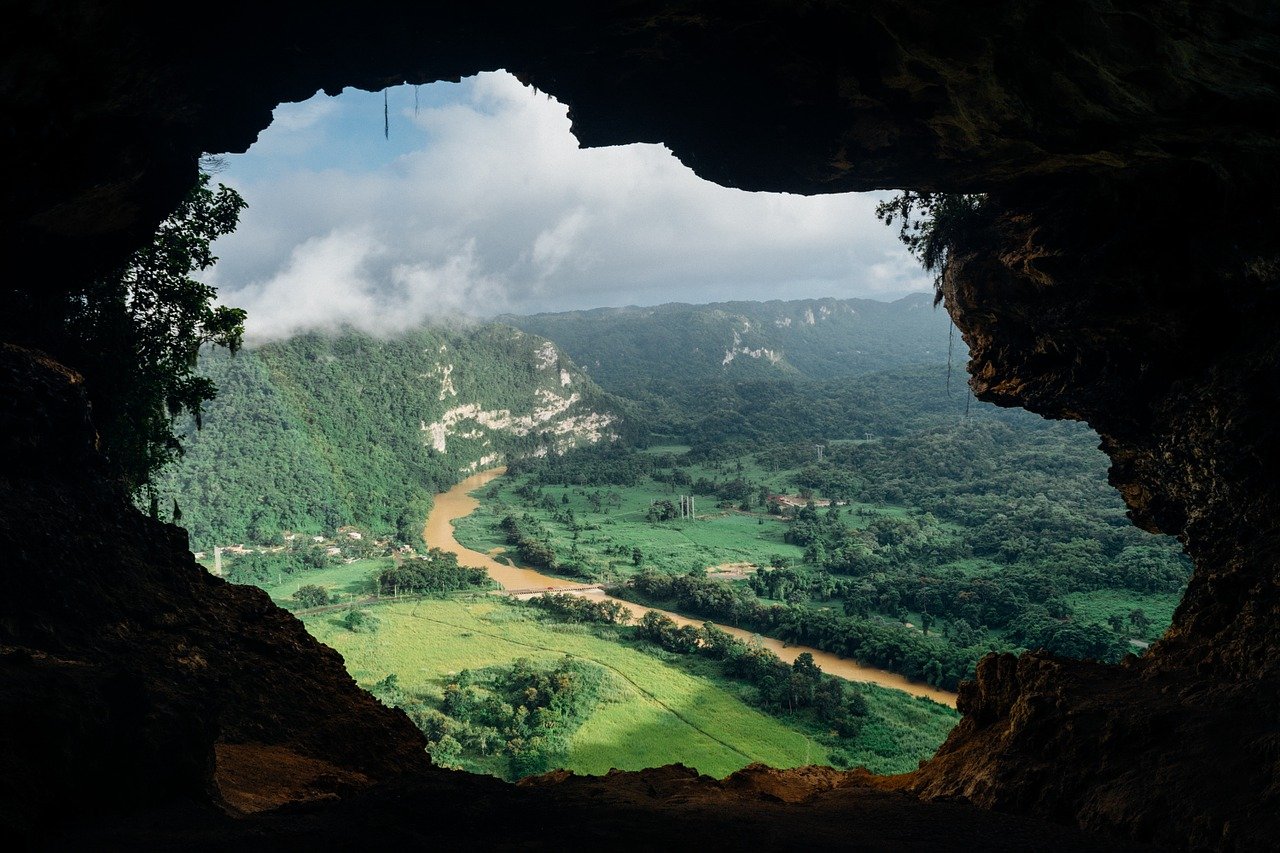 cave-828604_1280 a view of a large body of water with a mountain in the background