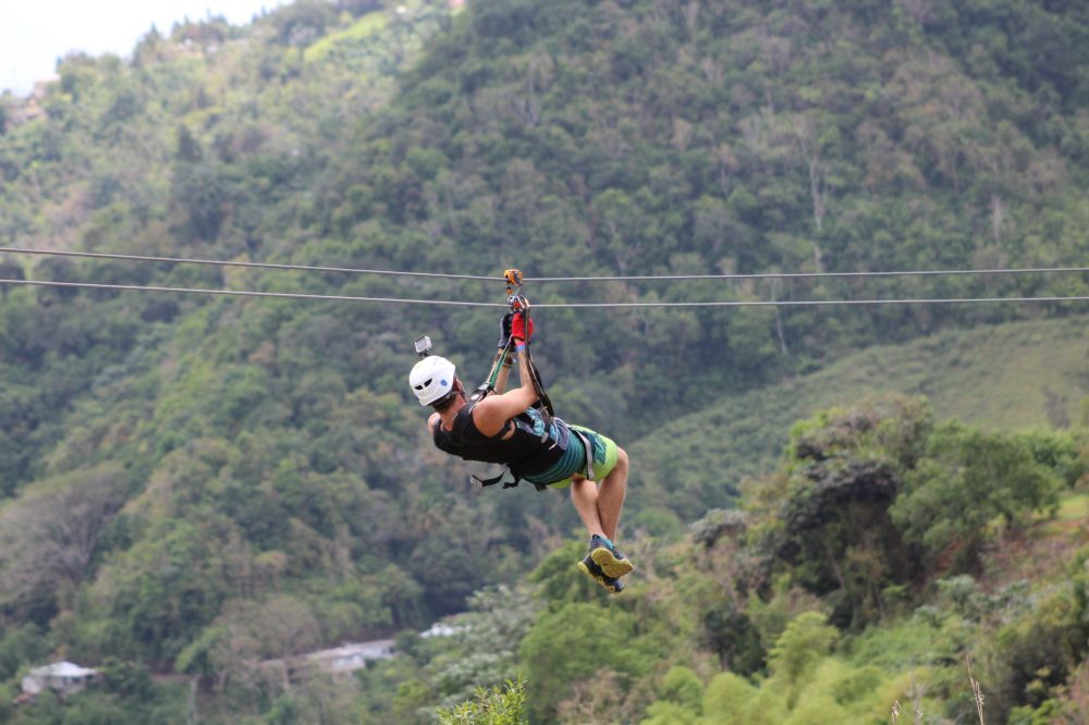 a man flying through the air on top of a hill