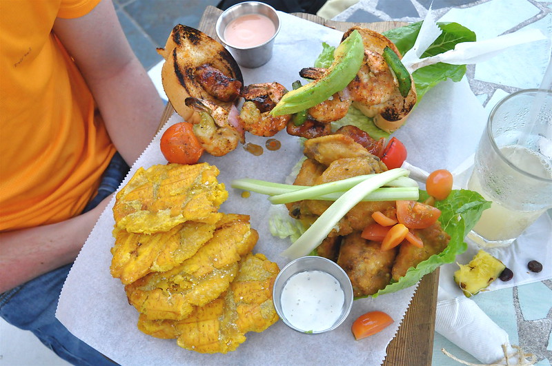 a person holding a bunch of food on a plate
