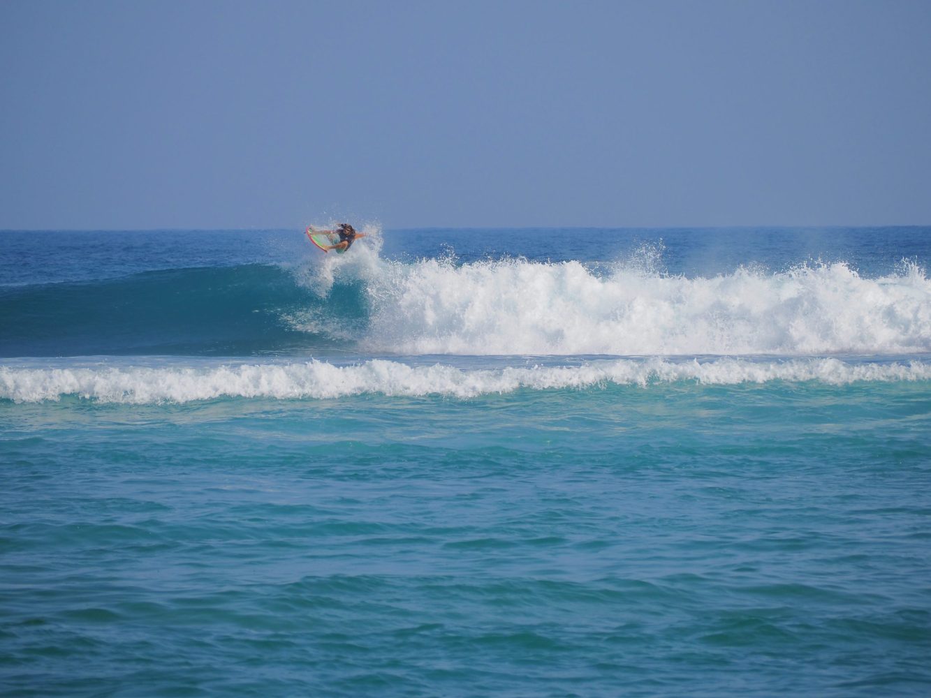 a man riding a wave on a surfboard in the ocean