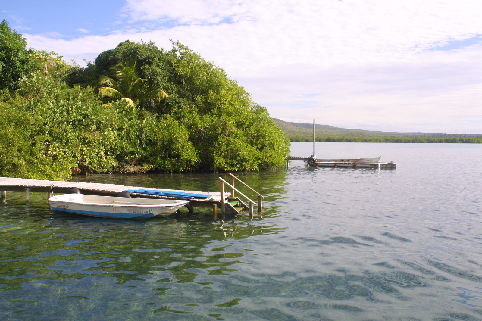 5897862762_da7e7c2701_h a small boat in a body of water