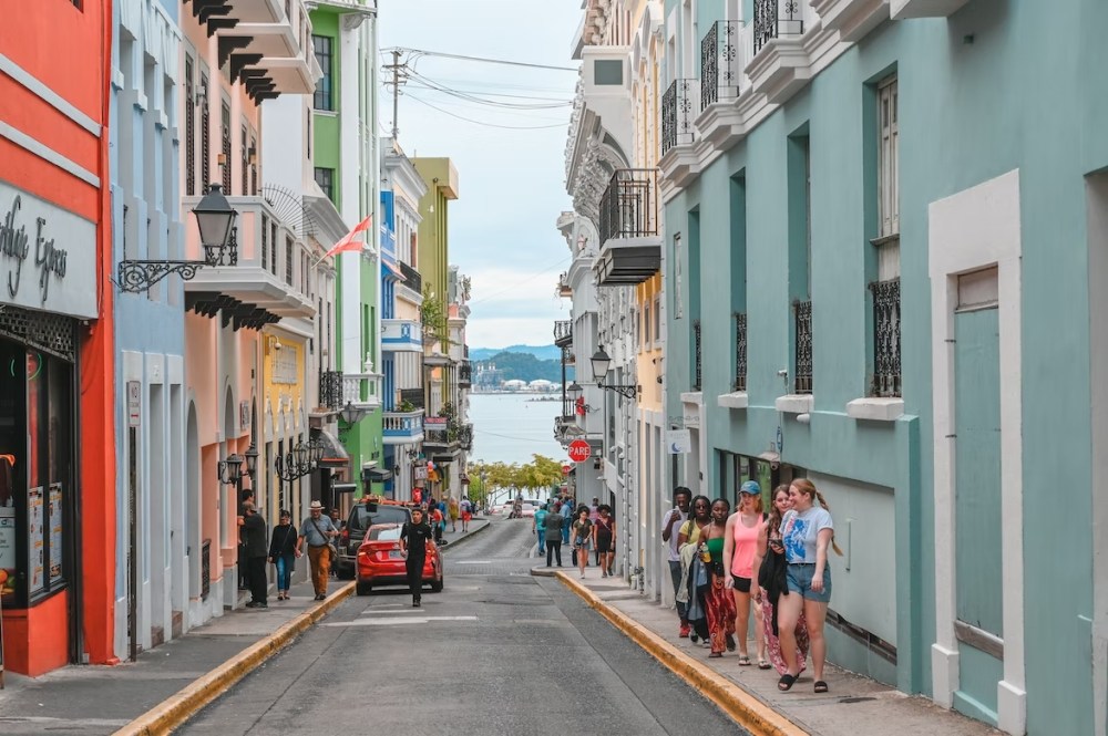 a group of people walking down a narrow street