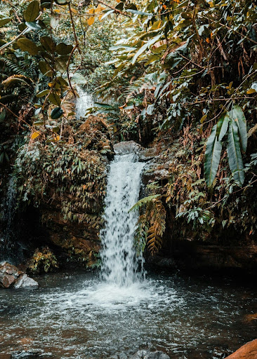 a large waterfall over some water